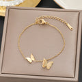 Pulsera con mariposas, acero titanio dorado
